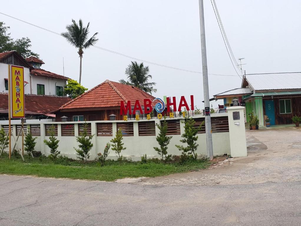 a building with a sign on the side of a street at Mabohai Resort Klebang in Melaka