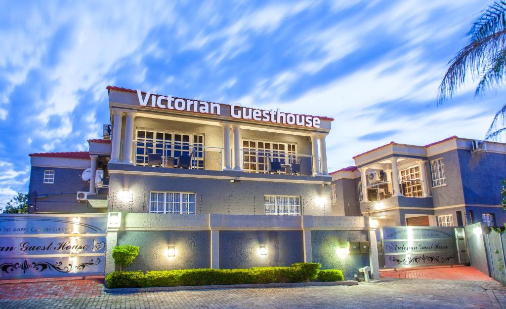 a building with a sign that reads victorian university at Victorian Guest House in Nelspruit