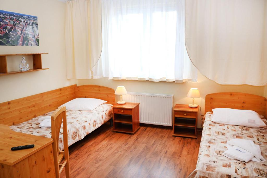 Postel nebo postele na pokoji v ubytování Ośrodek Wypoczynkowy Gryf II