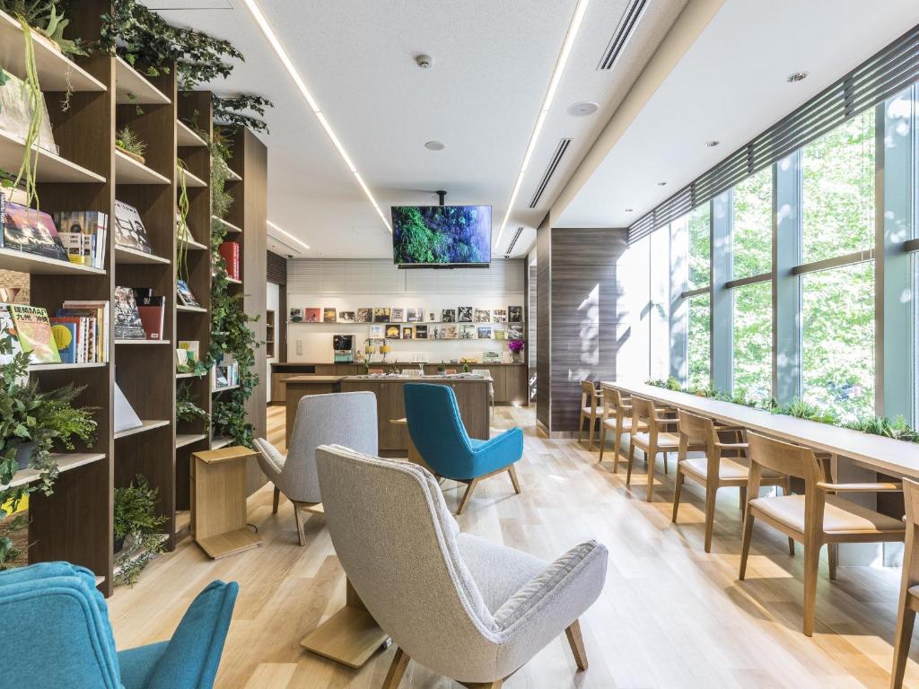 uma sala de espera com cadeiras e mesas e um balcão em Hotel Wing International Hakata Shinkansenguchi em Fukuoka