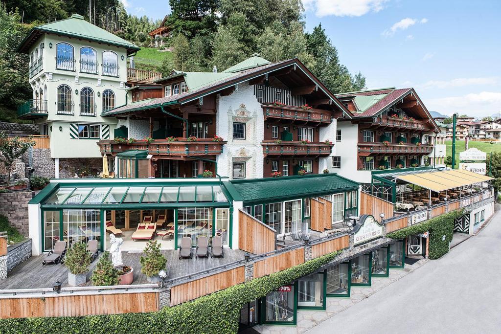 
a large building with a clock on the side of it at Wohlfühlhotel Garni KERSCHDORFER - adults only in Kaltenbach
