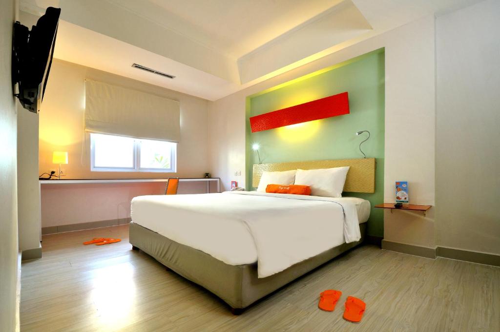 Postel nebo postele na pokoji v ubytování HARRIS Hotel & Residences Riverview Kuta, Bali