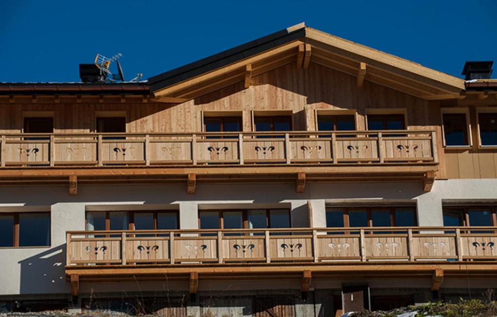 an apartment building with a balcony on top of it at Odalys Chalet De Marie in Les Menuires