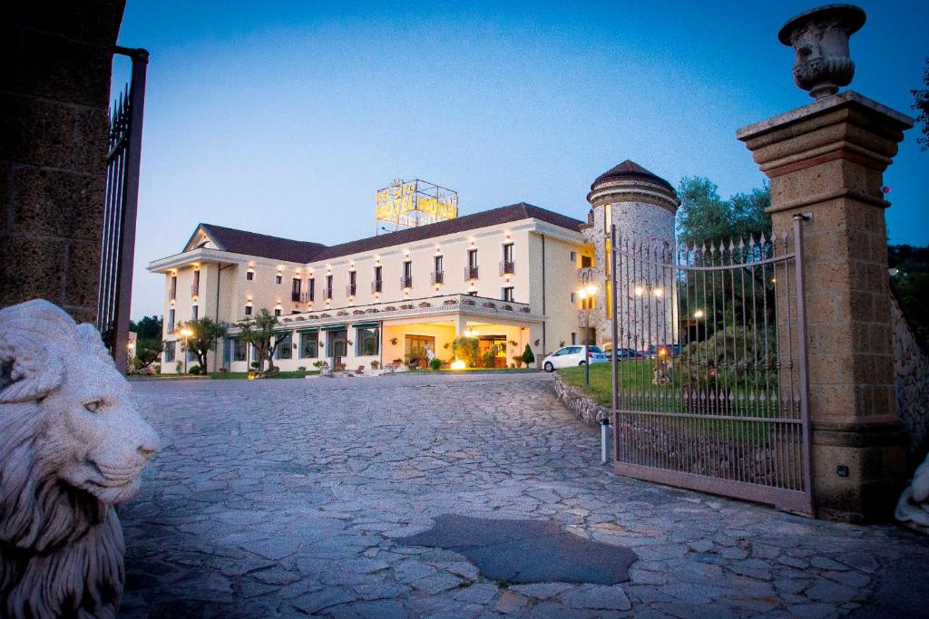 a building with a statue of a lion in front of a gate at Bel Sito Hotel Due Torri in Manocalzati