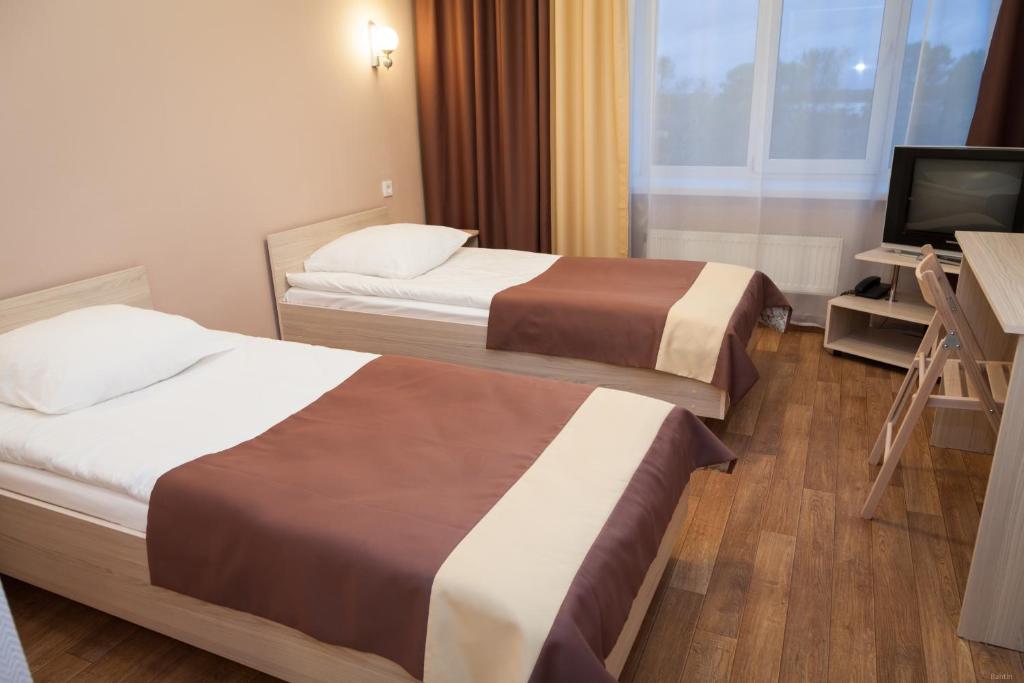 Postel nebo postele na pokoji v ubytování Spasskaya Hotel
