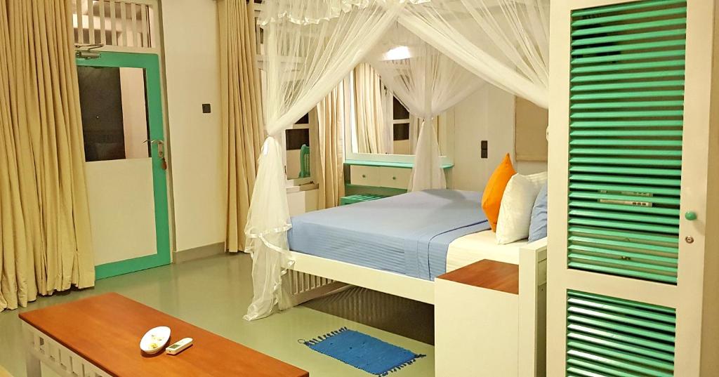 Postel nebo postele na pokoji v ubytování Neela's Beach Inn