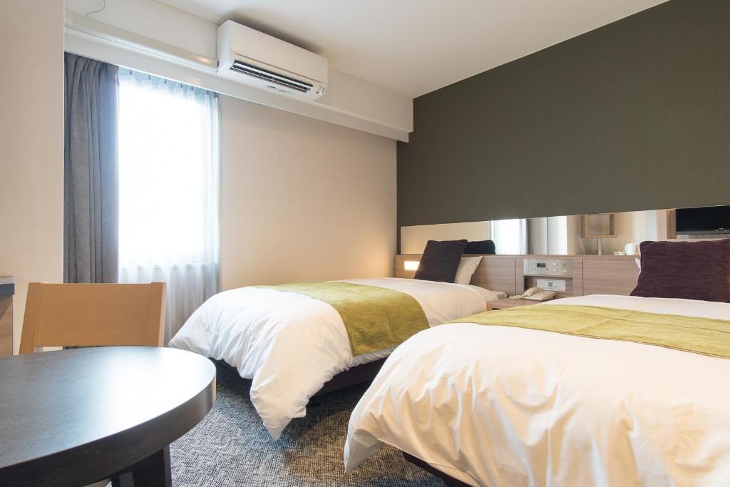 Postel nebo postele na pokoji v ubytování Fujinomiya Fujikyu Hotel