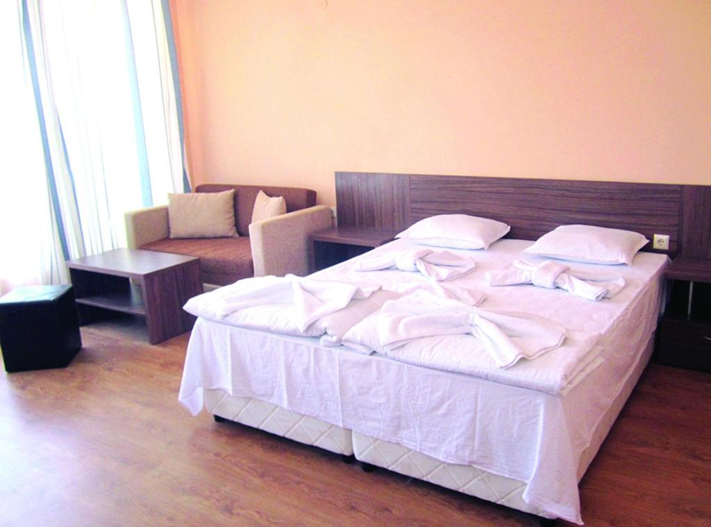 Postel nebo postele na pokoji v ubytování Hotel COOP Central