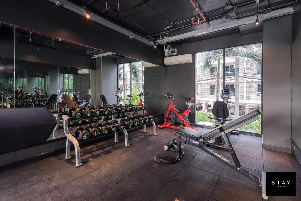 A compact gym combines free weights, a treadmill, a bike, and a cable station.