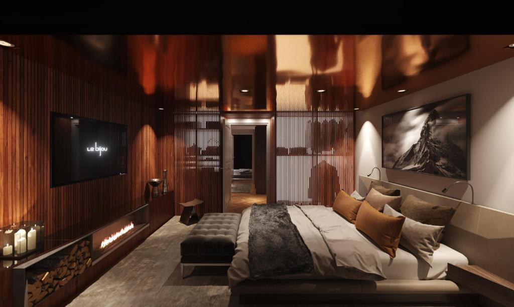 ein Schlafzimmer mit einem Bett und einem TV an der Wand in der Unterkunft Le Bijou LQ82 Spectacular Limmatview Penthouse in Zürich