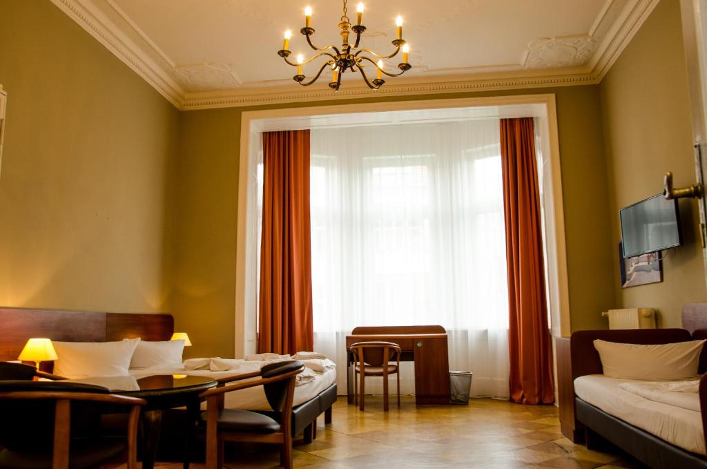 a living room filled with furniture and a large window at Hotel Astrid am Kurfürstendamm in Berlin