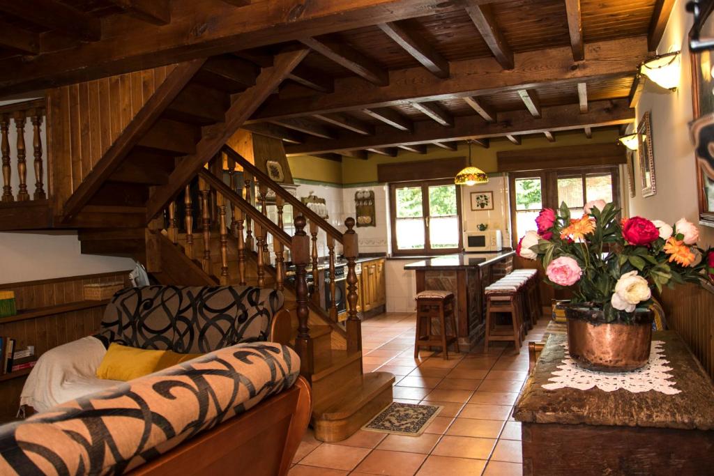a living room with a staircase in a house at Casa Rural La Regoria in Carreña de Cabrales
