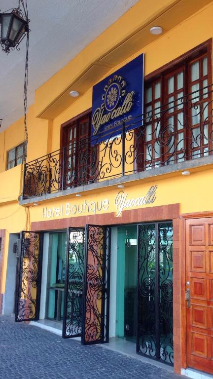 a hotel building with a sign on top of it at Hotel Yaocalli in San Martín de las Pirámides