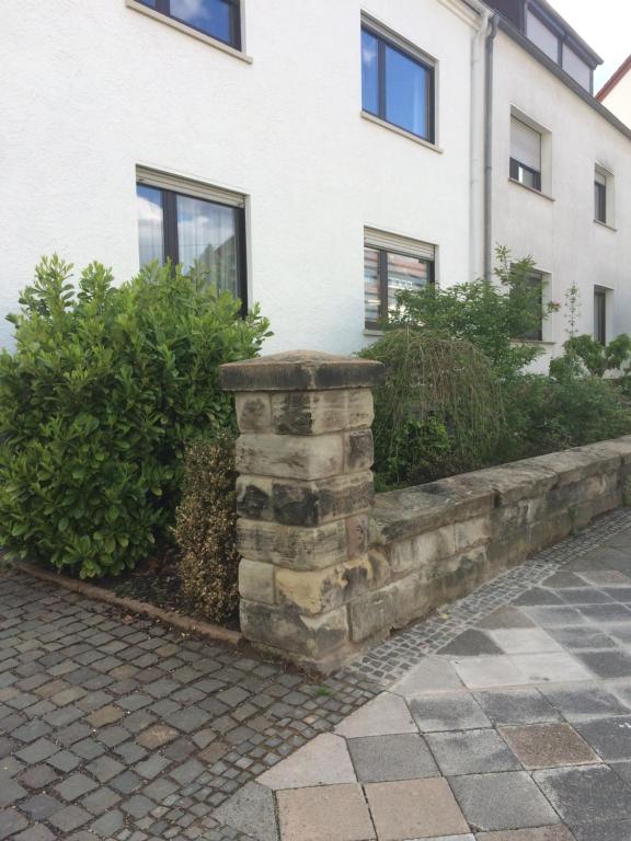 a stone retaining wall in front of a building at Ferienwohnung Am Homburg Nr 1 in Saarbrücken