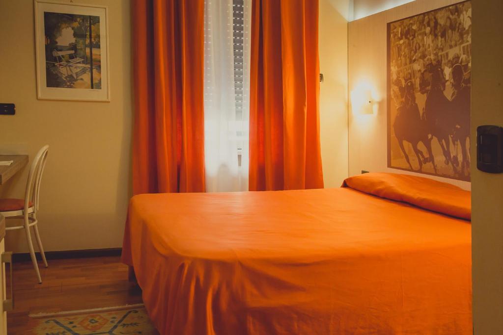 Postel nebo postele na pokoji v ubytování Hotel Rainero