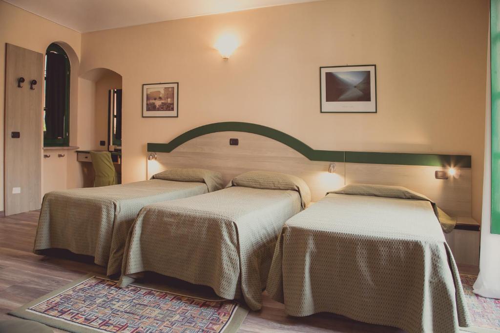Postel nebo postele na pokoji v ubytování Hotel Rainero
