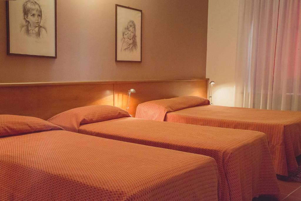 Postel nebo postele na pokoji v ubytování Hotel Rainero