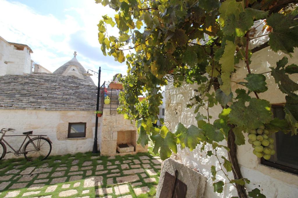 a bike parked next to a building with grapes at Il Gabellota Resort in Alberobello
