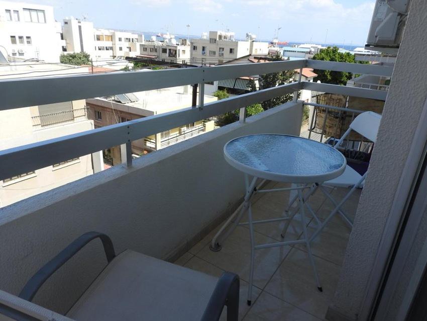 a balcony with a blue table and two chairs at One Bedroom aptm Larnaca in Larnaka