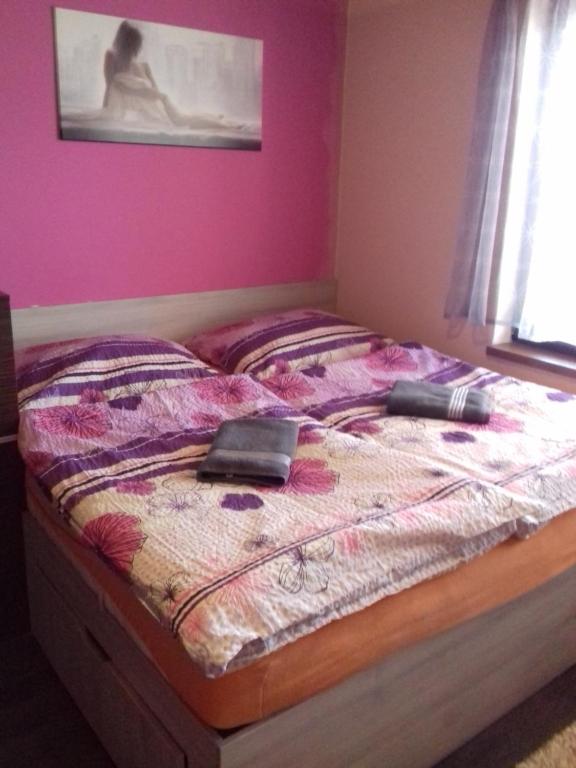 a bed with an ipad on it in a bedroom at Ubytování u Vlašiců in Moravská Nová Ves