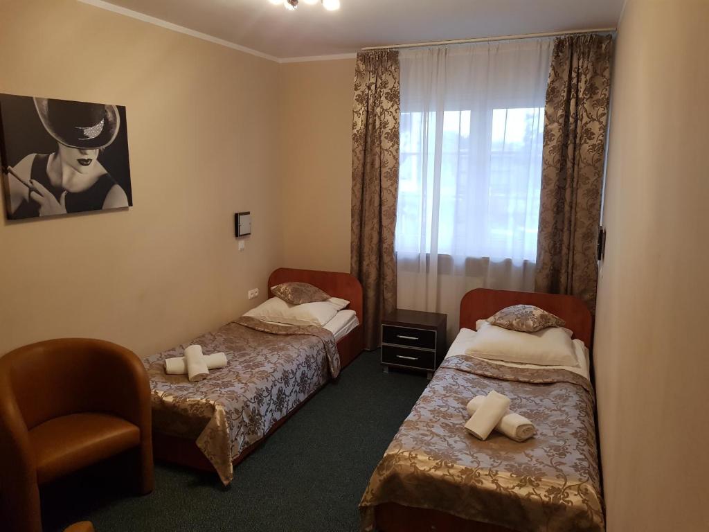Postel nebo postele na pokoji v ubytování Hotel Roko