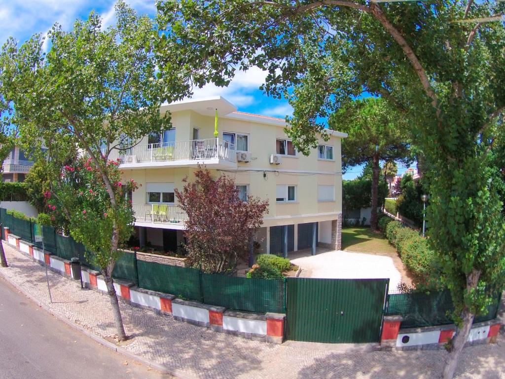 a white building with trees in front of it at Pine Tree Villa in Cascais