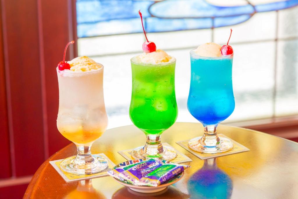 a group of three drinks sitting on a table at Kanazawa Hakuchoro Hotel Sanraku -Natural Hot Spring- in Kanazawa