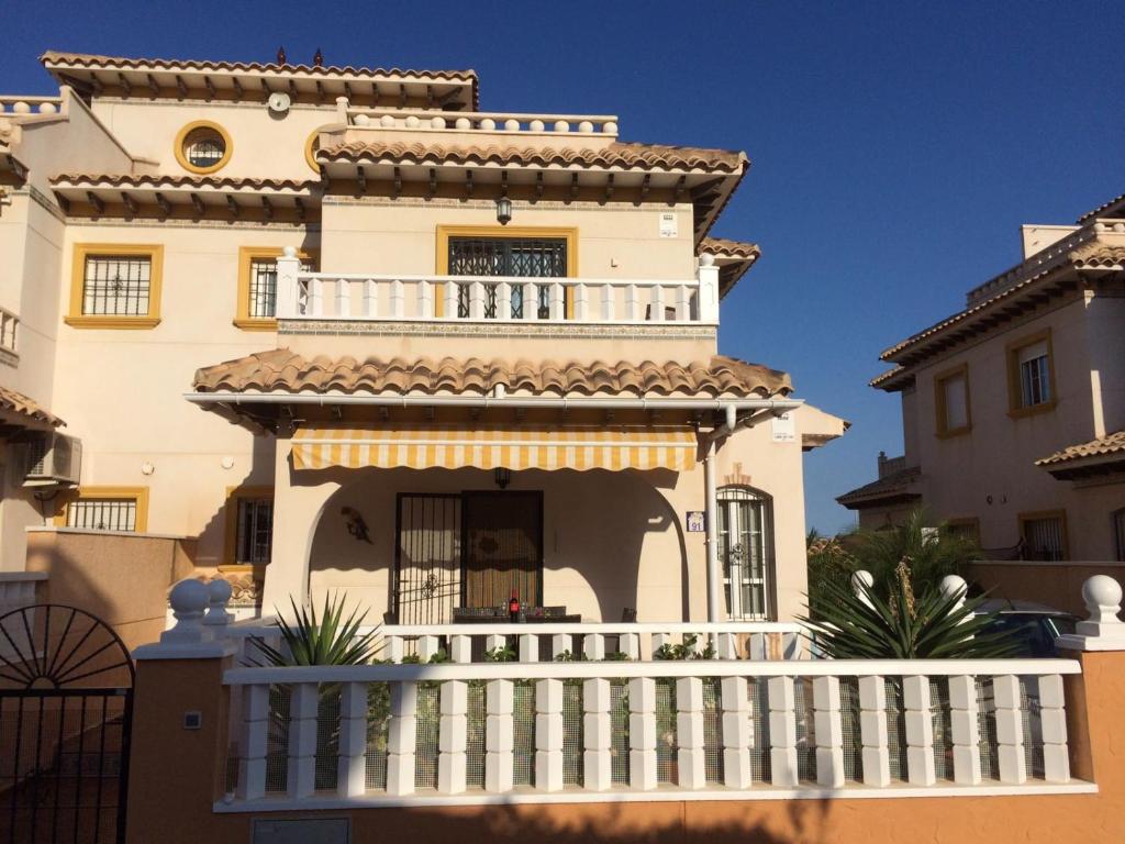 a large white house with a balcony at Lomas de Cabo Roig in Orihuela Costa