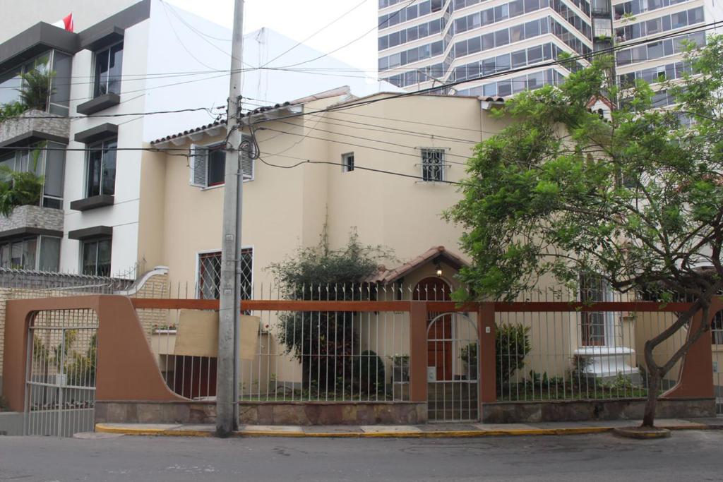 a building with a fence in a city at Casa Mirabonita in Lima