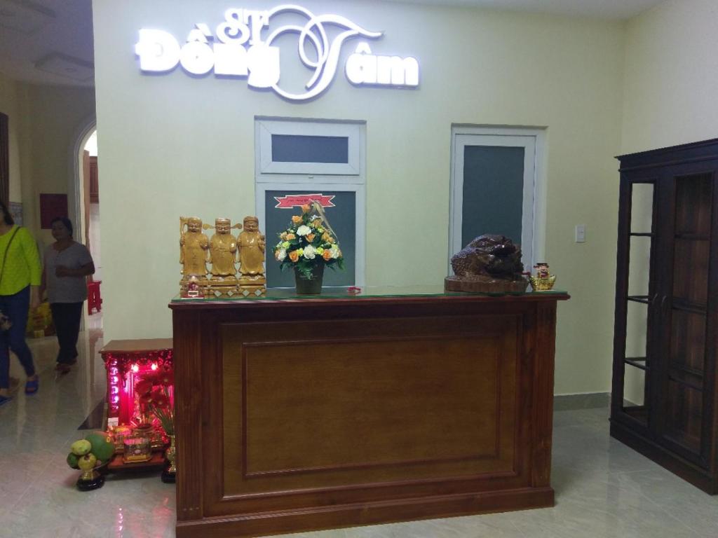 a shop with a counter with flowers on it at ST. Dong Tam Guesthouse in Da Lat