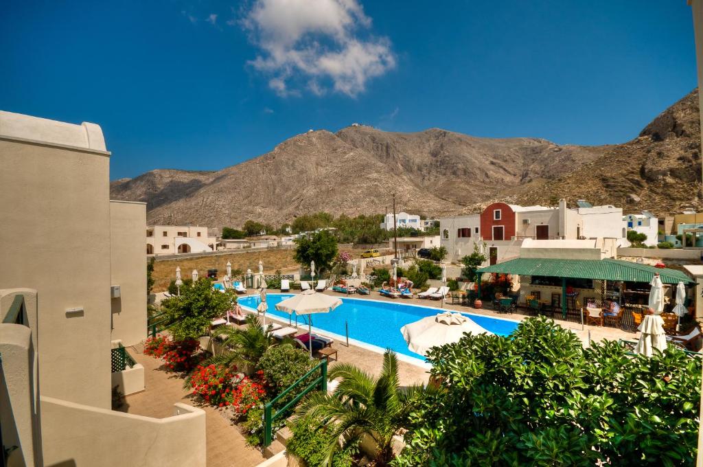 een resort met een zwembad en bergen op de achtergrond bij Phevos Villa in Perissa
