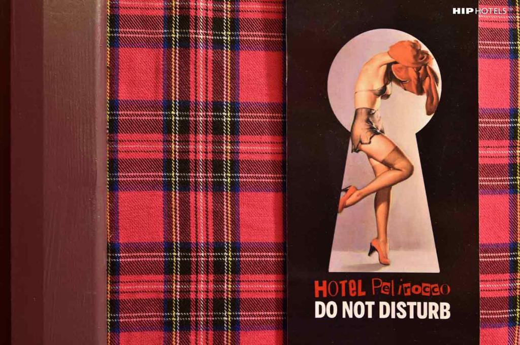 a picture of a woman in a pinocchiodo not disturb sign at Hotel Pelirocco in Brighton & Hove