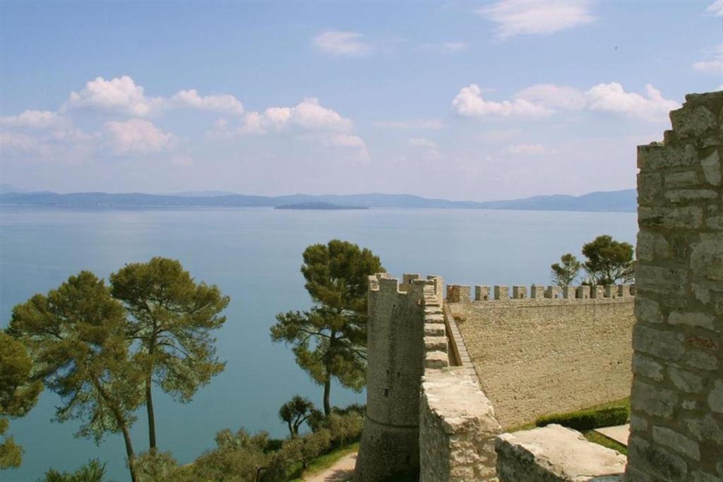 a view of the lake from the walls of a castle at Hotel La Torre in Castiglione del Lago
