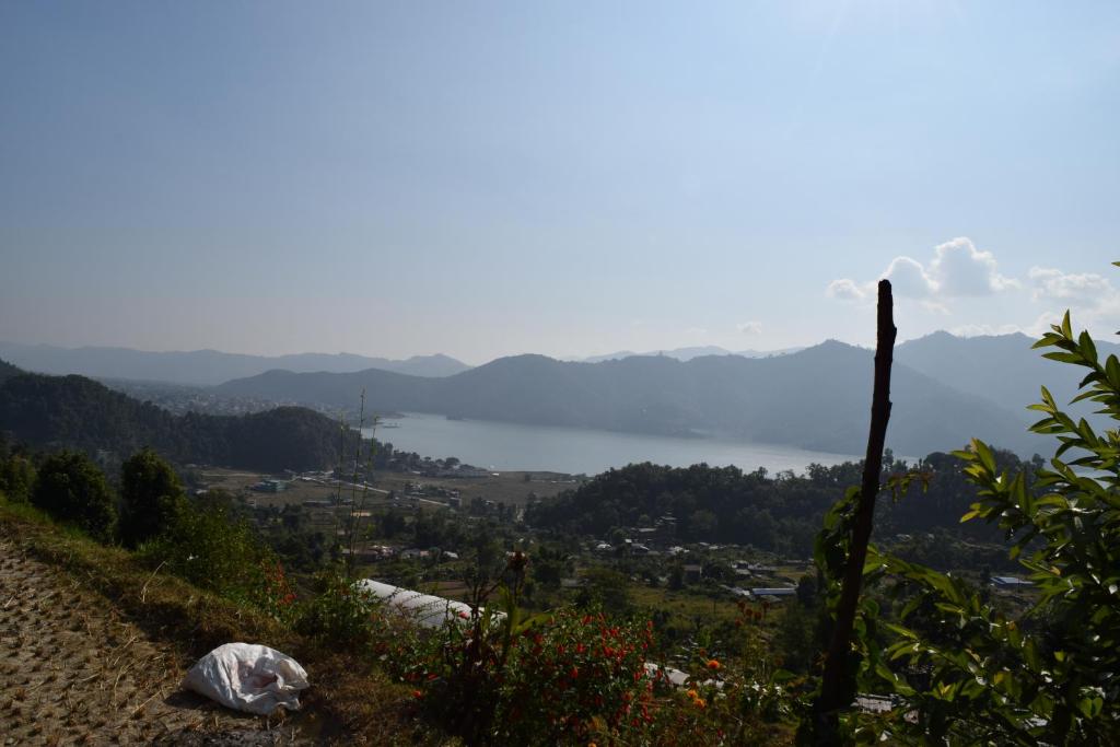 a view of a body of water from a hill at Gorgeous Village Guest House in Pokhara