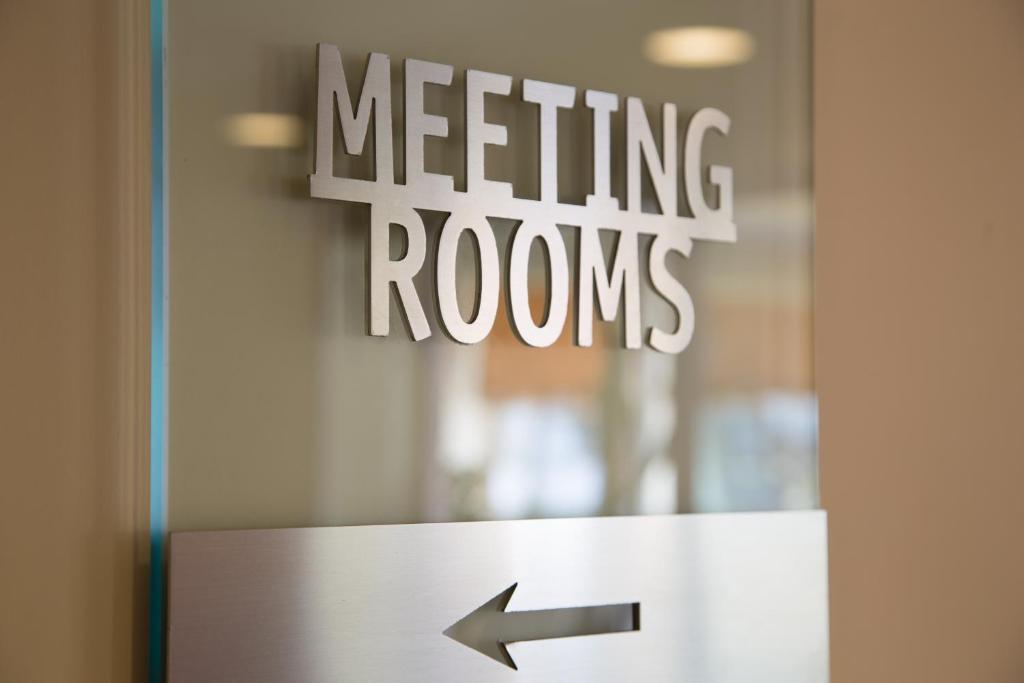 a door with a sign that reads meeting rooms at Hotel Mediterraneo in Livorno