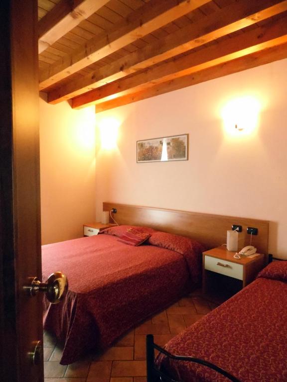 Postel nebo postele na pokoji v ubytování Hotel Agli Ulivi