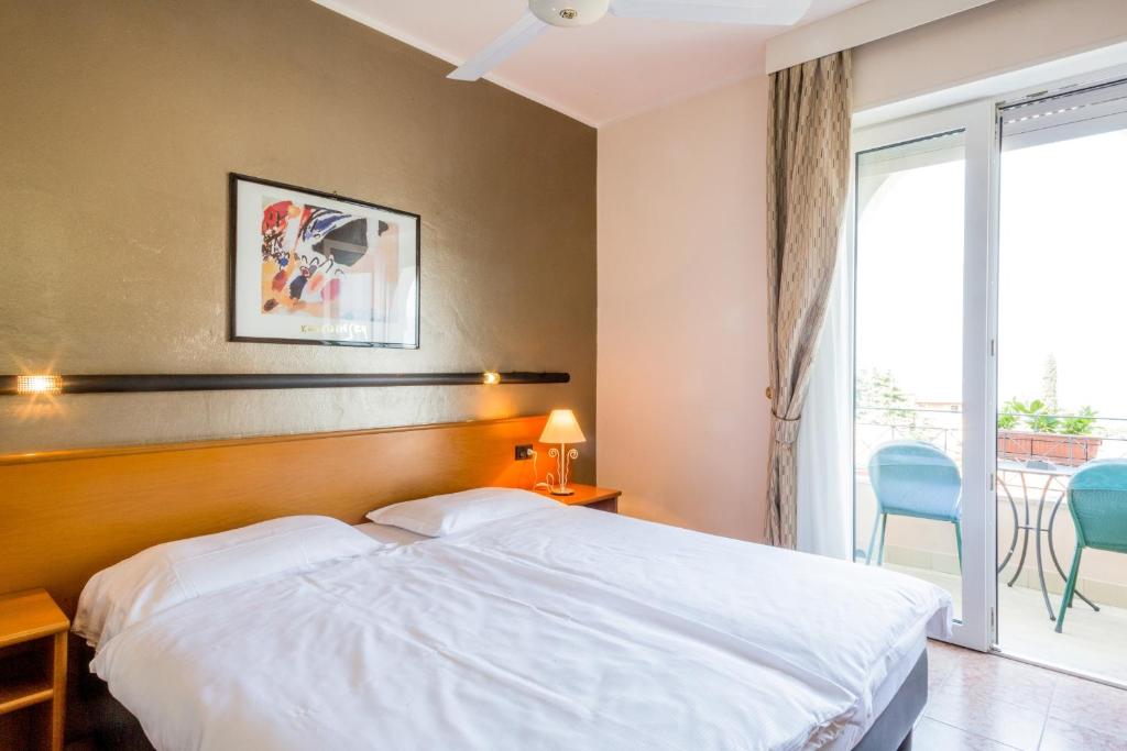 Postel nebo postele na pokoji v ubytování Hotel Pace