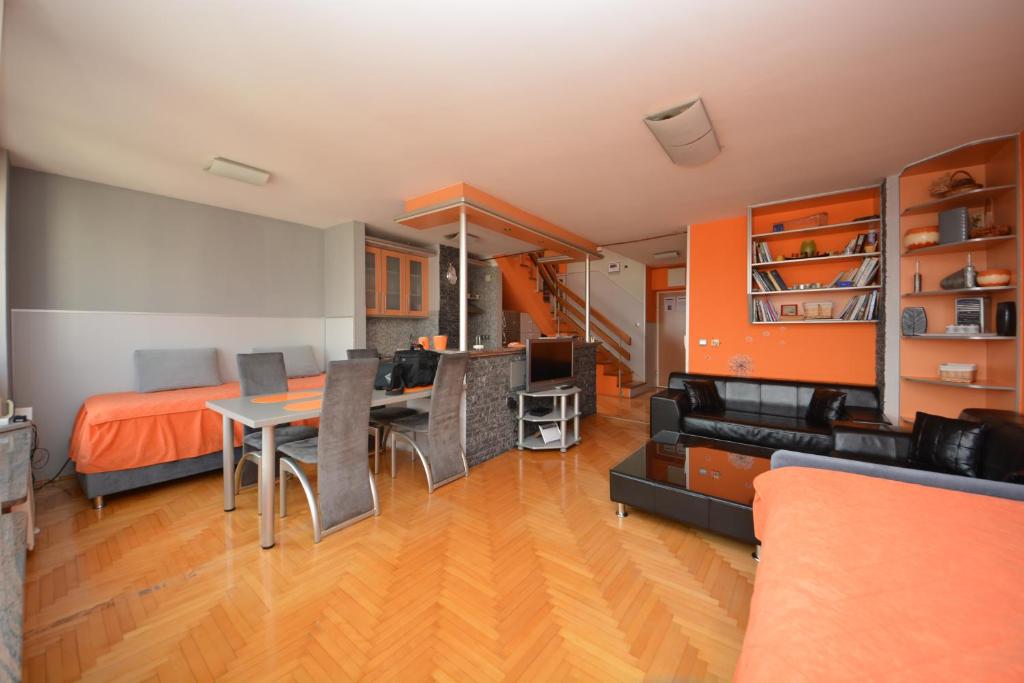a living room with a bed and a dining room at Best of Sarajevo Apartment in Sarajevo