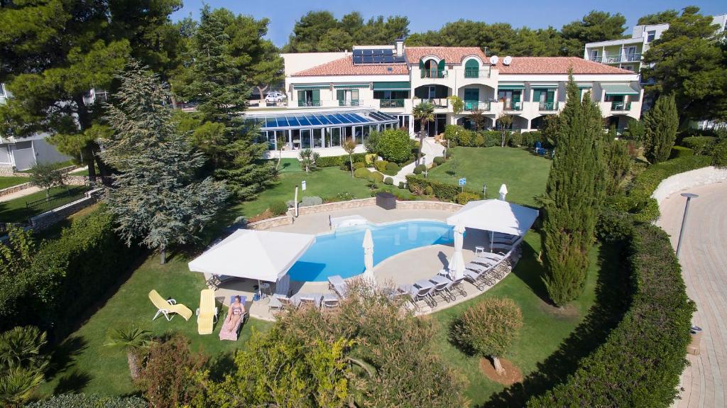 an aerial view of a house with a swimming pool at Hotel Villa Radin in Vodice