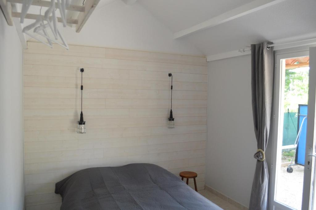 En eller flere senge i et værelse på Les Hauts de Chaudeyrac