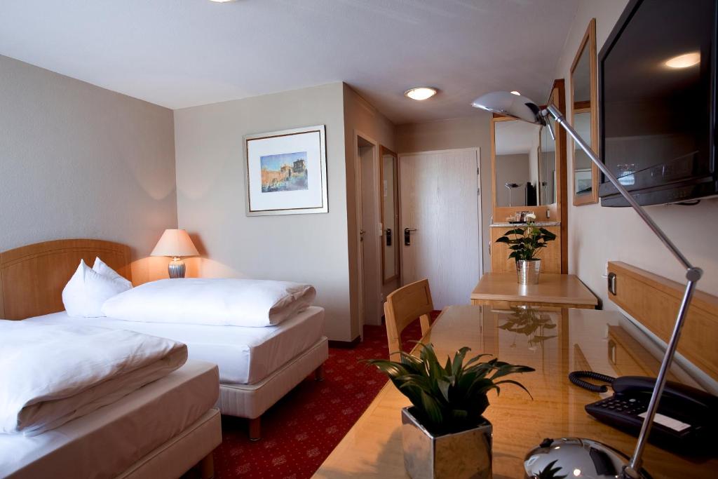 Postel nebo postele na pokoji v ubytování Hotel Das Kleine Ritz