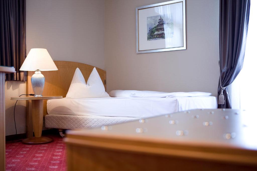 Postel nebo postele na pokoji v ubytování Hotel Das Kleine Ritz