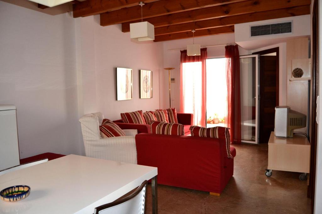 a living room with couches and a table at Casa Fayas in Ciutadella