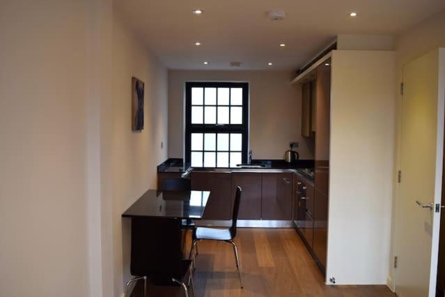 a kitchen with a table and chairs in a room at Kings Cross Apartment 5/Apartment in London