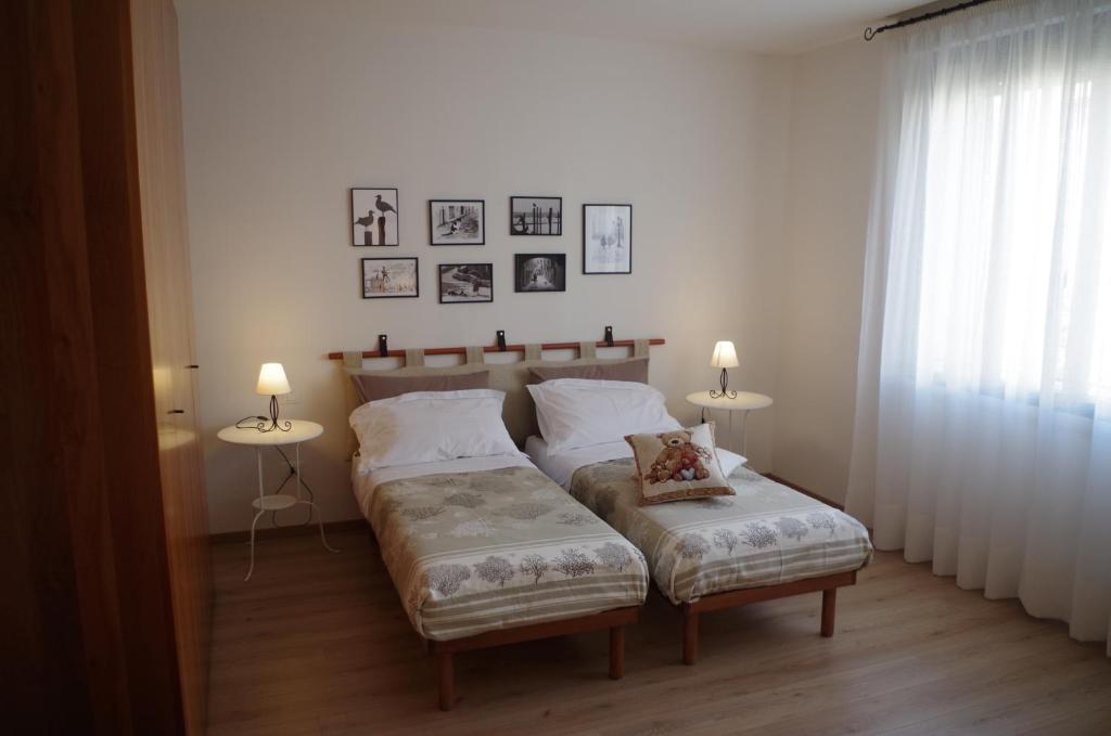 a bedroom with a bed and two tables and two lamps at Alla Torre B&B in Mestre