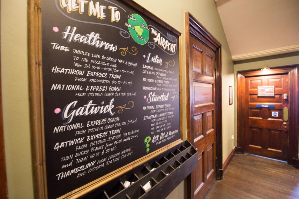 a chalkboard menu on the wall of a restaurant at Palmers Lodge Swiss Cottage in London