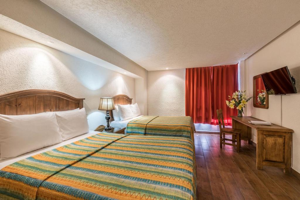 Postel nebo postele na pokoji v ubytování Hotel Abadia Tradicional