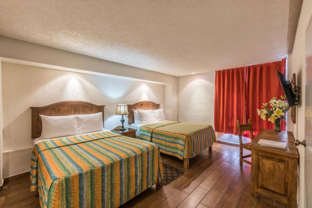 Postel nebo postele na pokoji v ubytování Hotel Abadia Tradicional