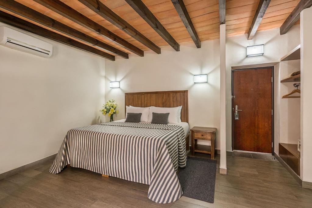 Postel nebo postele na pokoji v ubytování Hotel Abadia Tradicional