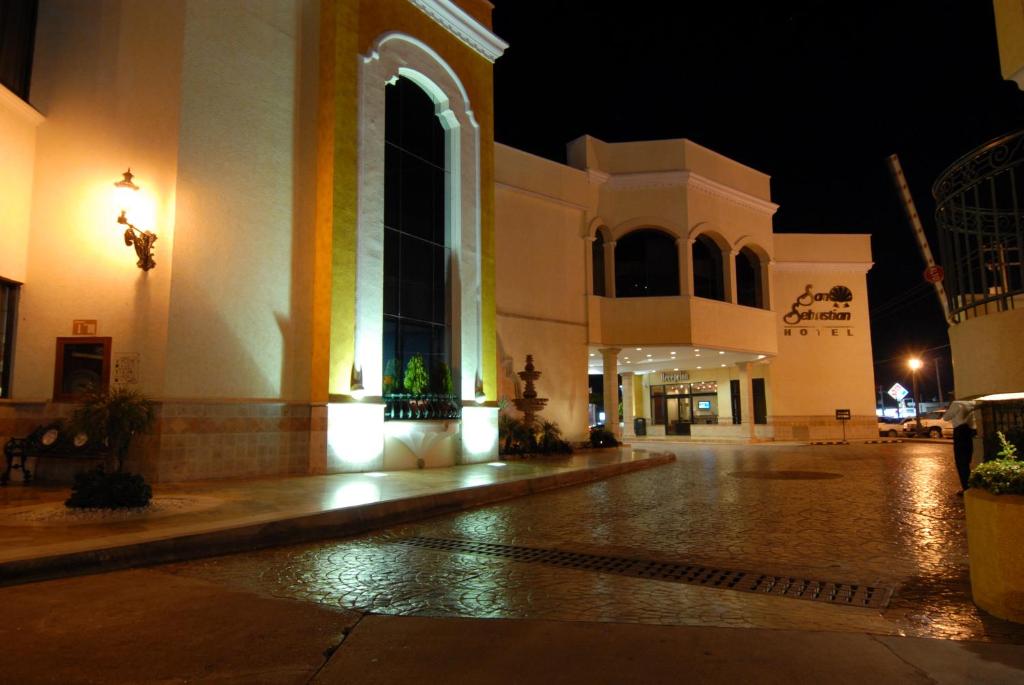 a large building at night with a street at Hotel San Sebastian in Hermosillo